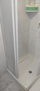 a shower in a bathroom with the door open at Alojamientos Rías Baixas in Vilagarcia de Arousa +4 photos