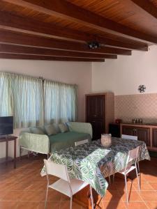a living room with a bed and a table and chairs at Relax e Natura a Carini in Carini