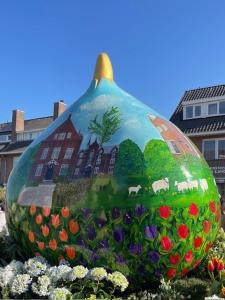 a large glass ball with a building painted on it at ZeeBedStay in Noordwijk aan Zee