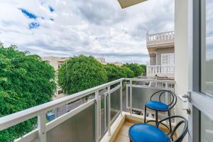 a balcony with two chairs and a view of trees at Spacious apartment with the private terrace in Arona +5 photos