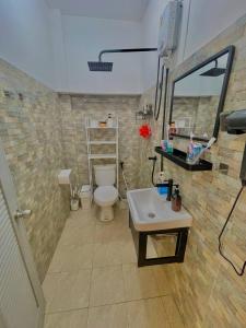 a bathroom with a toilet and a sink at Unity coliving in Thong Sala