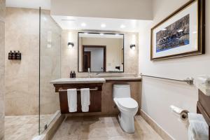a bathroom with a toilet and a sink and a mirror at The Lodge at Jackson Hole in Jackson