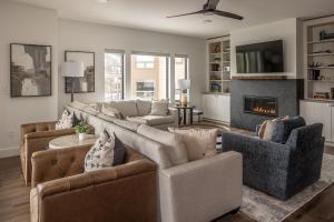 a living room with two couches and a fireplace at Beaverhead Condo - 5 Slalom #301 in Big Sky