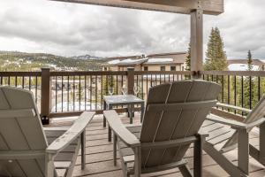 two chairs and a table on a deck at Beaverhead Condo - 5 Slalom #301 in Big Sky