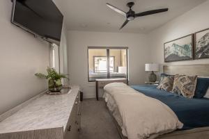 a bedroom with a bed and a ceiling fan at Beaverhead Condo - 5 Slalom #301 in Big Sky