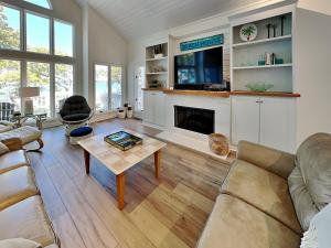 a living room with a couch and a fireplace at The Pack House in Topsail Beach