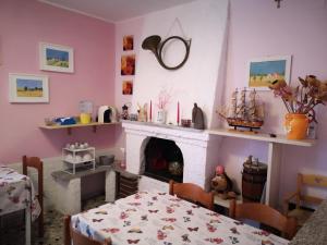 a living room with a fireplace and a table and a table and chairs at B&B Stella dell'Adriatico in Ortona
