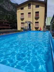 a large swimming pool in front of a building at Residence Armonia in Boario Terme