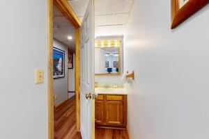 a bathroom with a sink and a mirror at Mountain Green - 2E3 in Killington +28 photos