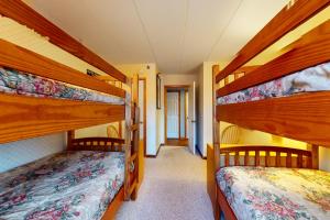 two bunk beds in a room with a hallway at Mountain Green - 2E3 in Killington