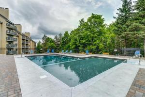 a swimming pool in a apartment complex with trees at Mountain Green - 2E3 in Killington