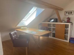 a dining room with a wooden table and a window at Ferienappartements REST - inkl. Chiemgau-Karte in Siegsdorf