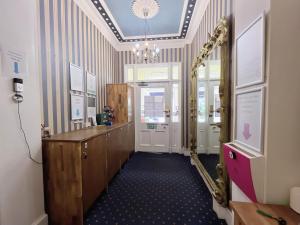 a hallway with a mirror and a desk in a room at Allison House 17 in Edinburgh