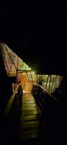a dark room with a wooden walkway at night at Casa en el Árbol - El Arca in Leticia