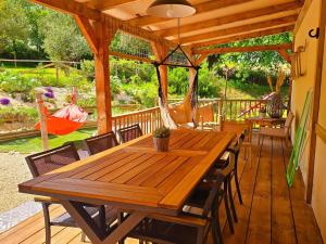 a wooden table and chairs on a deck at Casa Cingoli in Cingoli