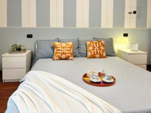 a bedroom with a bed with a tray of food on it at Holihome - La Suite dei Fiori in San Benedetto del Tronto