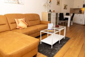 a living room with a couch and a table at Lord Nelson 115 in Döse