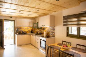 a kitchen with a table and a dining room at Cactus Aegina Apartments in Aegina Town