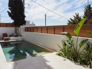 a swimming pool in the backyard of a house at Camara Athens Riviera Home in Aghia Marina