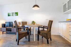 a kitchen and dining room with a table and chairs at Residenz am Balmer See - BS 55 mit Wellnessbereich in Balm