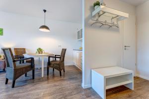 a kitchen and dining room with a table and chairs at Residenz am Balmer See - BS 55 mit Wellnessbereich in Balm +15 photos