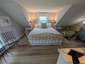 a bedroom with a large bed in a attic at Bourne Bed and Breakfast in Ogunquit