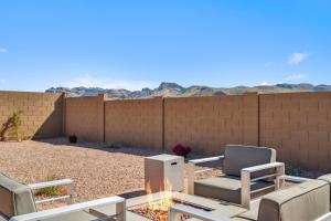 a patio with chairs and a table and a fence at The Arizona Hideaway in Gold Canyon