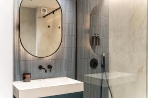 a bathroom with a white sink and a mirror at Fuengirola Playa y Centro in Fuengirola +30 photos