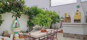 a patio with a table and chairs and plants at La Rosa Blu in Copertino
