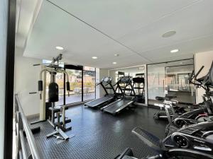 a gym with several treadmills and elliptical machines at New Cozy and Modern Gym Coworking Terrace in Bogotá