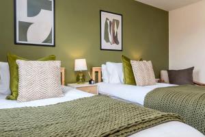two beds sitting next to each other in a room at NEW Greydawn House - Stunning 4 Bedroom House in Stoke-on-Trent in Stoke on Trent
