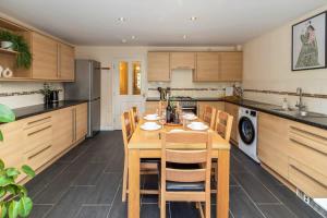 a kitchen with a wooden table and chairs at NEW Greydawn House - Stunning 4 Bedroom House in Stoke-on-Trent in Stoke on Trent