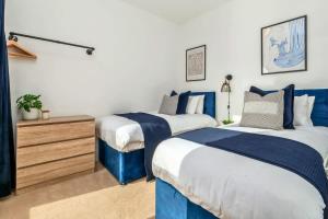 2 Betten in einem blau-weißen Zimmer in der Unterkunft NEW Canalside House / 3 Bedroom House in Stoke-on-Trent in Stoke on Trent