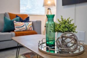 a green vase sitting on a table in a living room at Fielding House by Truestays - NEW 3 Bedroom House in Stoke-on-Trent in Stoke on Trent