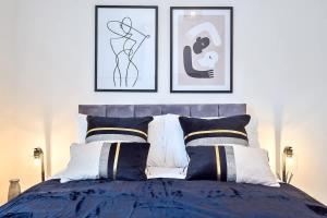 a bedroom with a bed with two pictures on the wall at Fielding House by Truestays - NEW 3 Bedroom House in Stoke-on-Trent in Stoke on Trent
