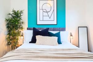 a bedroom with a white bed with blue walls at Penkhull House by Truestays - 4 Bedroom House in Stoke-on-Trent in Stoke on Trent