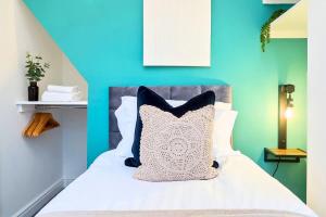 a bedroom with a bed with a blue wall at Penkhull House by Truestays - 4 Bedroom House in Stoke-on-Trent in Stoke on Trent