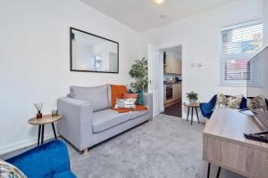 a living room with a couch and a table at Nursery House by Truestays - 3 Bedroom House in Stoke-on-Trent in Stoke on Trent
