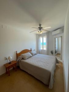 a bedroom with a bed and a ceiling fan at Alpen1 Residencial Edison in Peniscola +68 photos