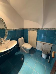 a blue bathroom with a toilet and a sink at A little paradise in Rafina +46 photos