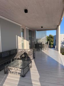 ein Balkon eines Hauses mit einem Tisch und Stühlen in der Unterkunft BUQEZ RESORT - Villa 55 in Drage