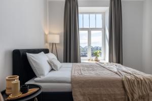 En eller flere senge i et værelse på P6 Old Town Apartments - 6th floor, no elevator