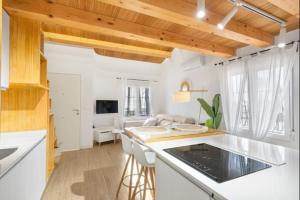 a kitchen with white counter tops and a living room at Luxury on the beachfront in El Campello