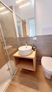 a bathroom with a sink and a toilet and a mirror at Esse & Emme in Palermo