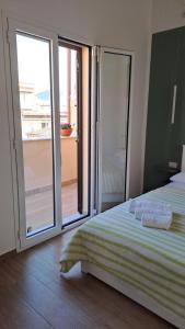 a bedroom with a bed and a sliding glass door at Esse & Emme in Palermo