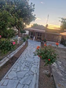 a stone walkway in front of a house at Kikas Stone House in Ávaton