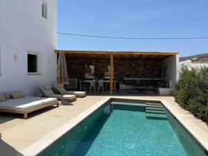 a swimming pool in front of a villa at Villa Olympia with private pool in Antiparos