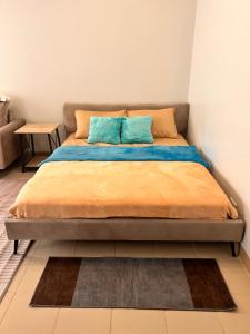 a bed with two pillows on it in a room at The Spot in Marilao