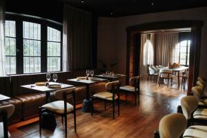 a dining room with tables and chairs and windows at Casa Toledo in La Cumbre