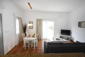 a living room with a table and a dining room at Olive garden house in Kalymnos